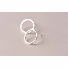 Load image into Gallery viewer, Polished sterling silver open circle studs on a plain background - Let's Jam jewellery, Camden Market, London
