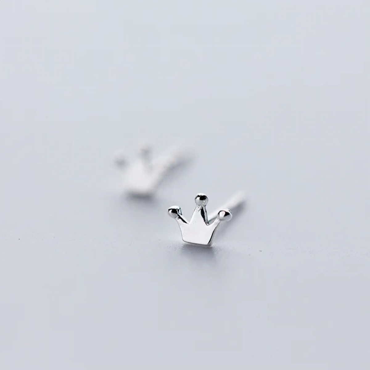 925 sterling silver tiny crown stud earrings, close-up shot of the crown design on a soft white background - Let's Jam jewellery collection