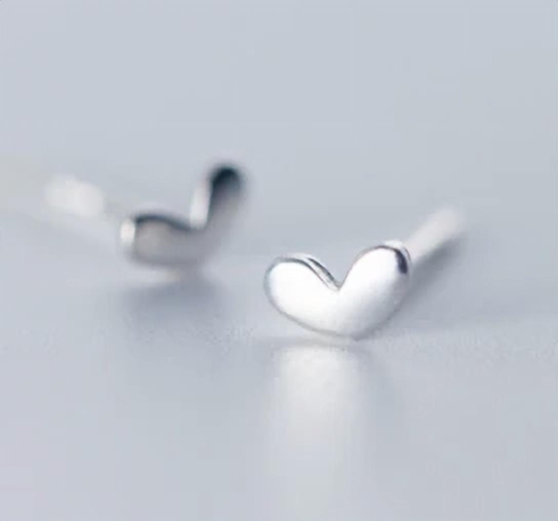 925 sterling silver tiny heart stud earrings, close-up shot showing the delicate heart shape on a soft white background - Let's Jam jewellery collection