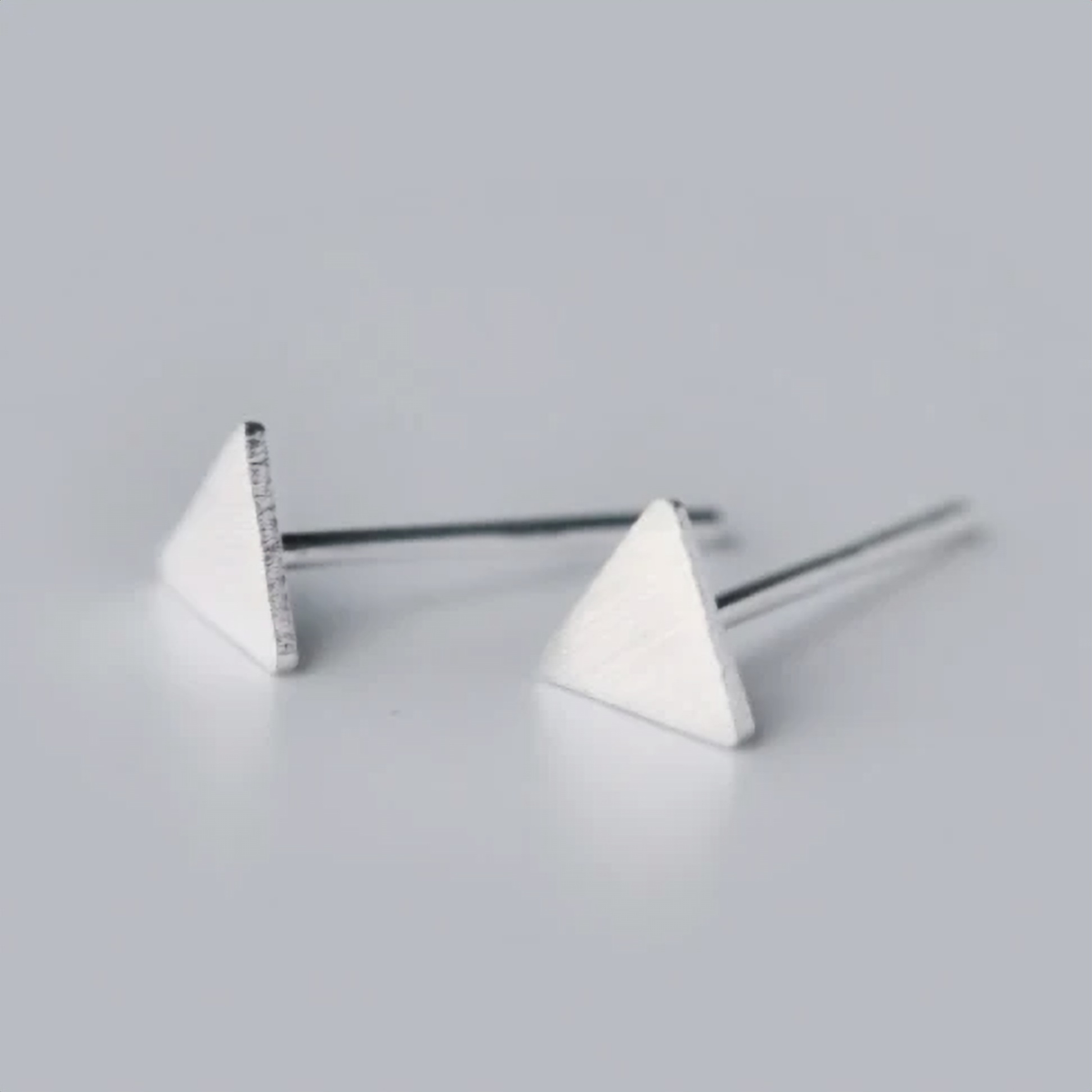 925 sterling silver triangle stud earrings, a minimalist geometric pair photographed on a white background - Let's Jam jewellery collection